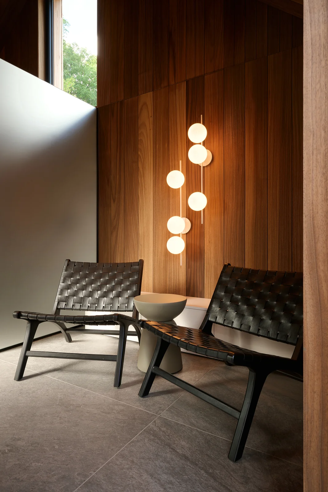 Two lounge chairs and glowing globe lamps in the sauna lounge