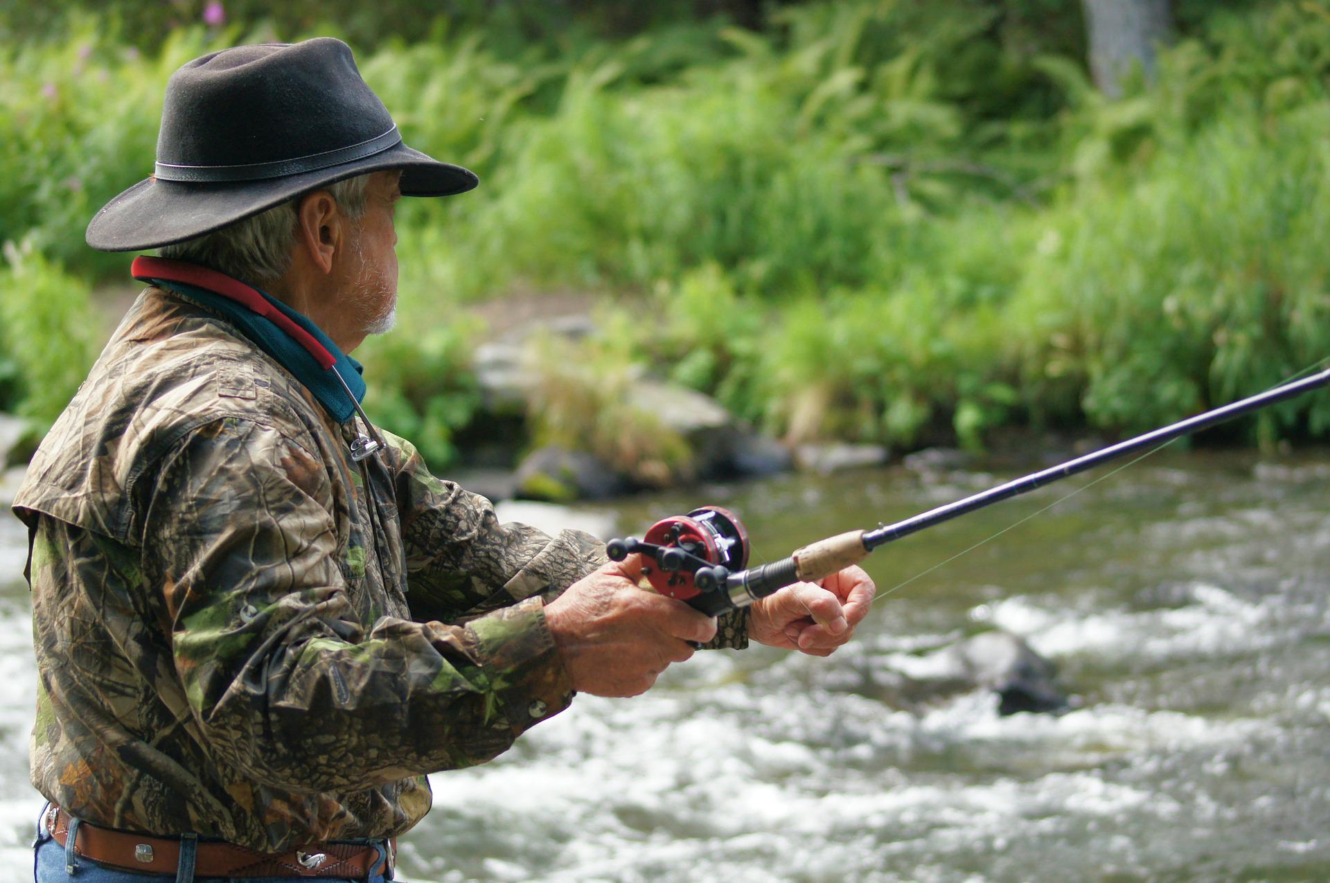 A fisherman with a rod above the water